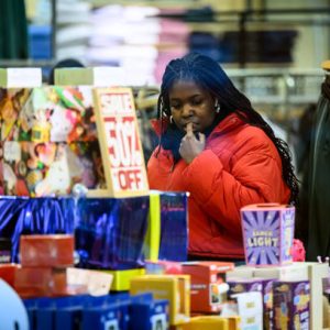 LONDON, ENGLAND - DECEMBER 13: A woman browses some of the Christmas gift ideas in a store on December 13, 2024 in London, England. UK retail sales figures during the Christmas period are forecast to reach a peak at £88.3 billion this year.  (Photo by Leon Neal/Getty Images)